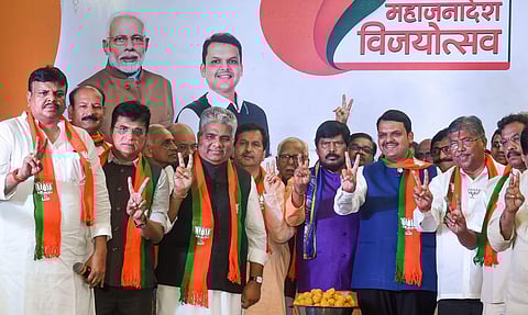 Maharashtra Chief Minister Devendra Fadnavis State BJP president Chandrakant Patil senior leader Bhupendra Yadav RPI chief Ramdas Athawale and other leaders flash victory signs as they celebrate their win in Maharashtra Assembly elections in Mumbai. (Phot