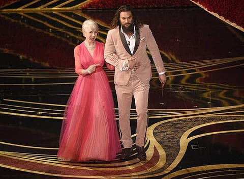 Helen Mirren, left, and Jason Momoa presented the award for best documentary feature at the Oscars. (Photo | AP)