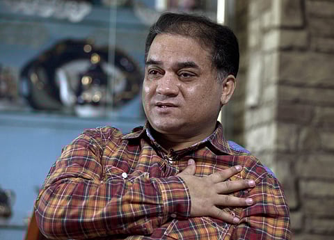 Scholar of China's Turkic Uighur ethnic minority, Ilham Tohti speaks during an interview at his home in Beijing (File Photo | AP)