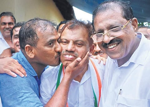 A party worker kisses M C Kamaruddin, who won the Manjeshwar bypoll, in front of the counting centre at Paivalige on Thursday | Express
