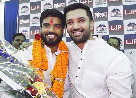 LJP parliamentary board chairman Chirag Paswan poses with the party's newly elected MP from Samastipur Prince Raj during a press conference in Patna Friday. (Photo | PTI)