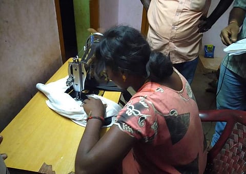 Sujith's mother Kalaimary stitching a cloth bag in which they hoped to bring her son up after expanding it inside the borewell. (Photo | EPS)