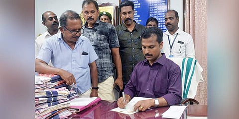 Mayor V K Prasanth looking at files on his first day back in corporation after winning Vattiyoorkavu bypoll. (Photo | Vincent Pulickal, EPS)