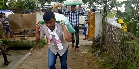 Rupjyoti Kurmi, the three-time Mariani MLA in Assam’s Jorhat district, had carried sacks of flood relief on his back in July 2017. (File Photo | Twitter)