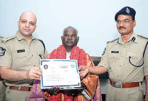 Andhra Pradesh police officials handing over relief fund cheque (Photo |EPS)