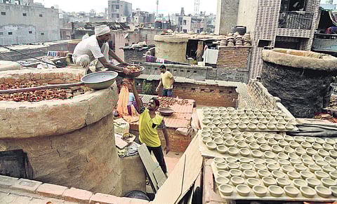 Pre-Diwali scenes at Kumhar Gram with the potter community moulding clay diyas and firing these at traditional kilns that the government wants to replace with gas furnaces. | ( Photo | Parveen Negi )