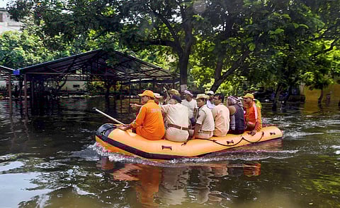 National Disaster Response Force NDRF and police personnel inspect a flood-affected area of Rajendra Nagar after heavy rains in Patna. (Photo | PTI)
