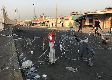 People walk on the curfew-ed street of Baghdad. (Photo| AP)