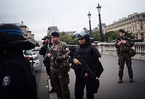 Armed police officers and soldiers patrol after four police officers were killed in a knife attack. (Photo| AP)