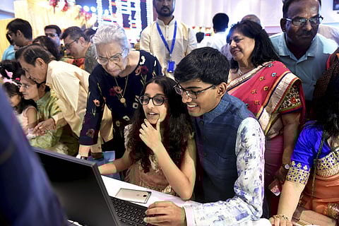 Stockbrokers trade as their family watch during a special 'muhurat' trading session for Diwali at BSE in Mumbai on 27 October 2019. (Photo | PTI)