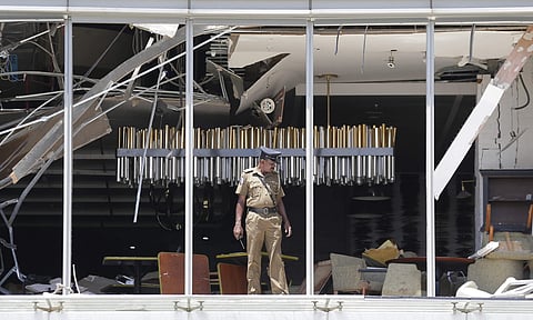 File photo of a Sri Lankan Police officer inspects a blast spot at the Shangri-la hotel in Colombo. (Photo | AP)