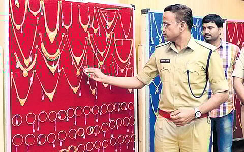 SP S Senthil Kumar examining the gold ornaments recovered in Andhra Bank theft case in Chittoor on Wednesday | express