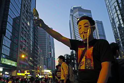 A protester wears a mask during a protest in Hong Kong.(Photo|AP)