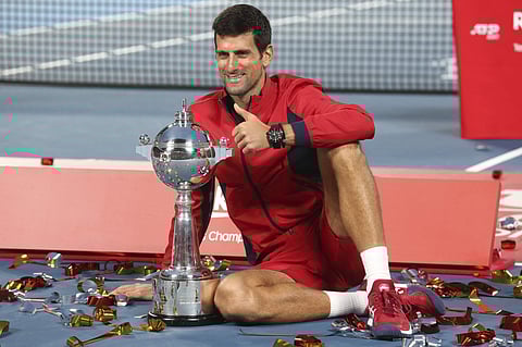 Novak Djokovic of Serbia poses with his champion trophy during the award ceremony of the Japan Open. (Photo | AP)