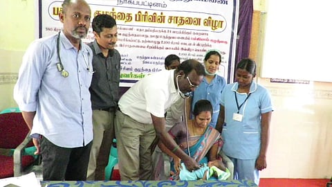 The mother Latha receiving the child from the doctors and nurses on Friday after treated to health in Nagapattinam general hospital. (Photo | EPS)