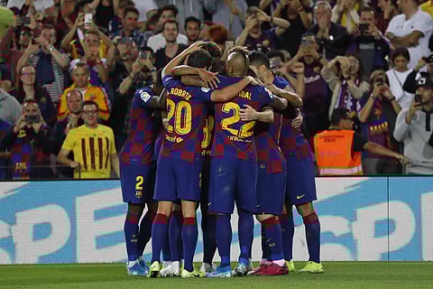 Barcelona players celebrate after teammate Ousmane Dembele scored their side's third goal. (Photo | AP)
