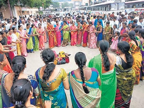 Women conductors expressing their resentment against government with Bathukamma songs in front of Karimnagar Depot-1 on Sunday (Photo |EPS)