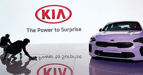 Workers tidy up the venue before a press conference by Kia Motors in New Delhi on Tuesday (Photo | Jatin Adhlakha)