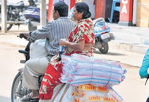 File picture of a couple carrying disposable plastic glasses in Hyderabad