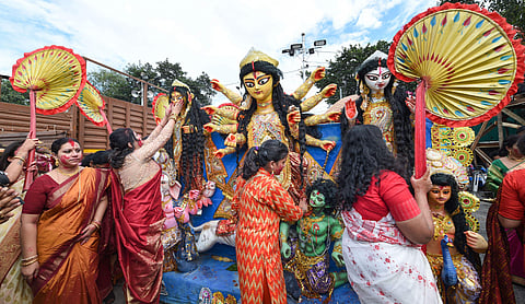 Married Hindu women perform rituals as they celebrate Vijaya Dashami Dussehra before the immersion of an idol of Goddess Durga in River Ganga in Kolkata. (Photo | PTI)