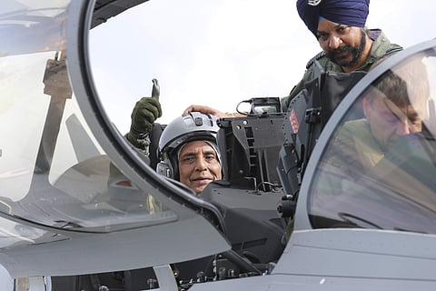 Indian Defense Minister Rajnath Singh thumbs up as he sits in a Rafale jet fighter during an handover ceremony at the Dassault Aviation plant in Merignac, near Bordeaux, southwestern France, Tuesday, Oct. 8, 2019. | (Photo | AP)