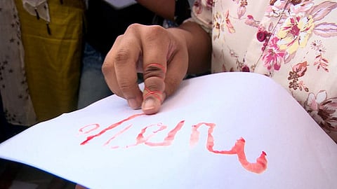 Children writing 'Sathyam' (truth) with their own blood at a protest gathering held at Kothamangalam Church in Ernakulam, Kerala. (Photo | Special Arrangement)