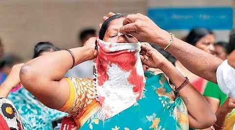 A woman protester bleeding profusely after being injured during the police lathi charge