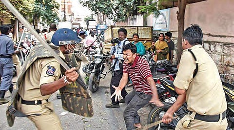 Policemen resort to lathi charge after TSRTC employees, among thousands of protesters, tore down barricades at Tank Bund in Hyderabad on Saturday. (Photo | Vinay Madapu, EPS)