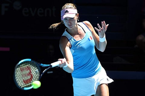 Kristina Mladenovic of France hits a return against Ashleigh Barty of Australia during the third rubber of the Fed Cup tennis final match between Australia and France in Perth. (Photo | AFP)