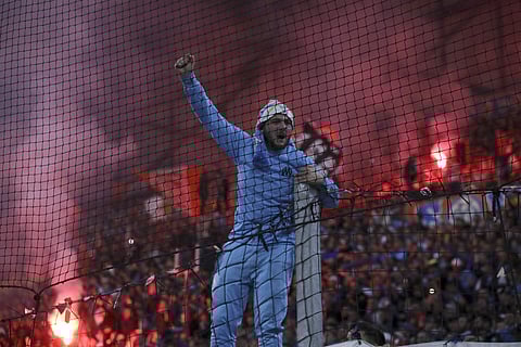 A Marseille fan celebrates his side's second goal against Lyon. (Photo | AP)