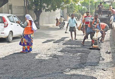 File photo of GHMC workers filling potholes in Jubliee Hills