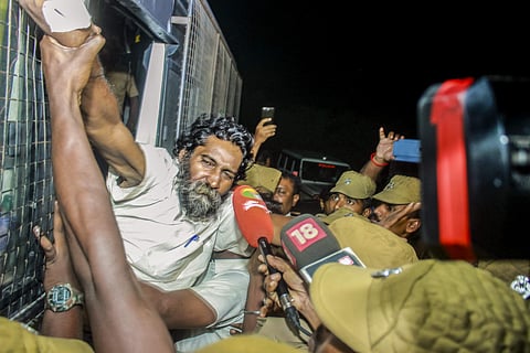 Social activist Mugilan being escorted by the police in Karur. (File photo | EPS)