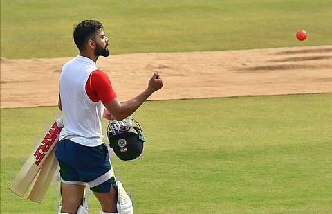 Indian cricket captain Virat Kohli throws the new pink ball ahead of the first Test match against Bangladesh in Indore. (Photo | PTI)