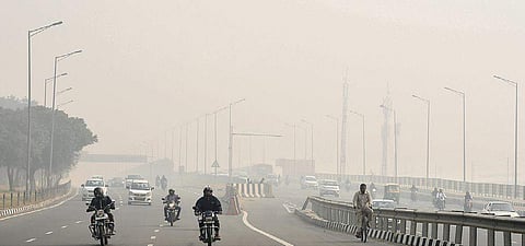 Commuters out and about as a thick layer of smog blankets New Delhi. (Photo| EPS/ Parveen Negi)