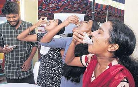 Students eating live oyster at the food and Agri-Aqua festival at CMFRI in Kochi. The food item with rich medical value was brought to the fest from the farm fields after depuration A Sanesh