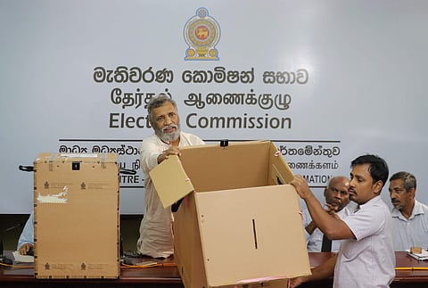 Sri Lanka's elections chief Mahinda Deshapriya displays ballot boxes that will be used in the upcoming presidential election. (Photo| AP)