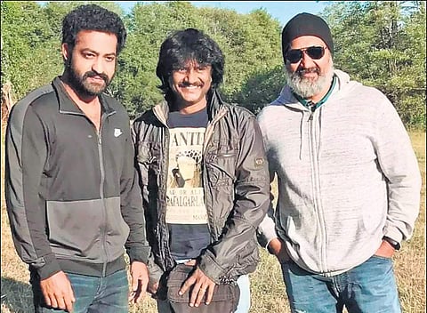 Jr NTR, a crew member and SS Rajamouli on the sets of RRR