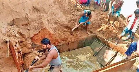 Workers salvaging the wreckage of the launch boat on banks of Brahmani river.