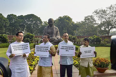 Congress MP Gaurav Gogoi and other MPs display placards to protest against proposed privatisation of Numaligarh Refinery during the Winter Session of Parliament in New Delhi Tuesday. (Photo | PTI)