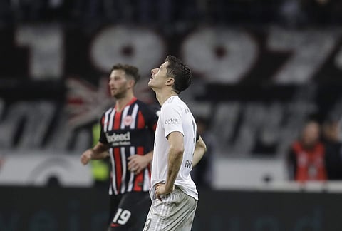 Bayern's Robert Lewandowskilooks up as he waits fro the restart after Frankfurt scored their 5th goal of the game. (Photo | AP)
