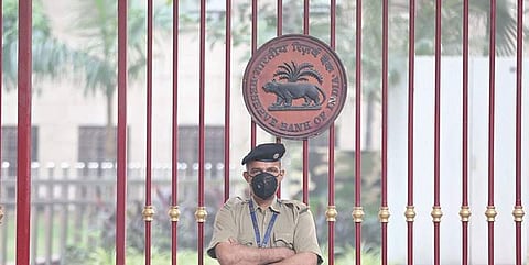 A security personnel posted in front of Reserve Bank of India wears a face mask for protection from air pollution in New Delhi on Friday (Photo | Shekhar Yadav)