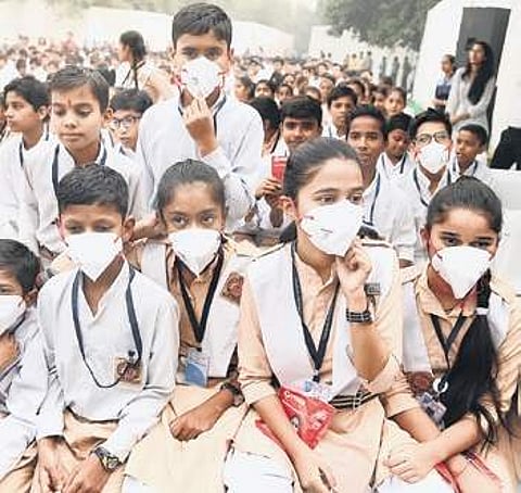 Students after receiving pollution masks from Chief Minister Arvind Kejriwal. ( Photo | EPS, Parveen Negi )