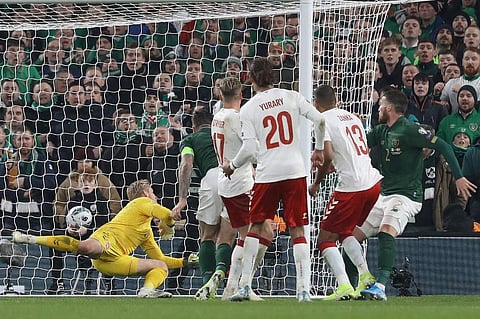Republic of Ireland's defender Matt Doherty (R) watches his header beat Denmark's goalkeeper Kasper Schmeichel (L) for their first goal during the Group D Euro 2020 football qualification match. (Photo | AFP)