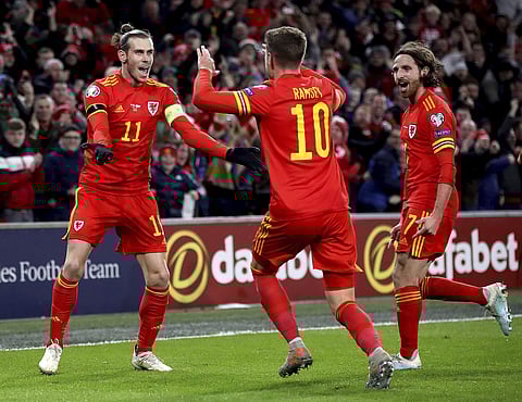 Wales' Aaron Ramsey celebrates scoring his side's first goal with team-mates Gareth Bale and Joe Allen. (Photo | AP)