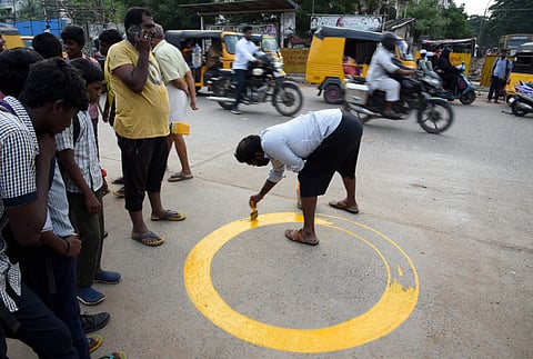 A man marking the danger zone after the Head Constable Palani Kumar was run over by a truck at the Mullai Nagar - SM Nagar Main road junction on Wednesday night in Chennai. (Photo | EPS)