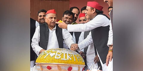 Samajwadi Party founder Mulayam Singh Yadav being offered sweets by his son and party President Akhilesh Yadav during his 81st birthday celebrations, at party office in Lucknow. (Photo | PTI)