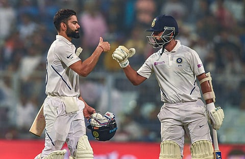 Indian Skipper Virat Kohli and teammate Ajinkya Rahane return to the dressing room at the end of the first day. (Photo | PTI)