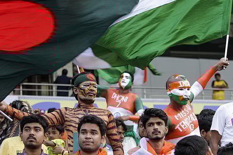 A Bangladeshi supporter cheers along with Indian fans during the first day of the second Test in Kolkata. (Photo | AP)