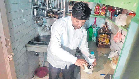 DJB vice-chairman Dinesh Mohaniya collecting a water sample from a house. (Photo | Twitter)