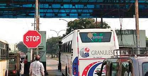 A private bus entering the fastag lane at a toll plaza. (Photo | EPS)